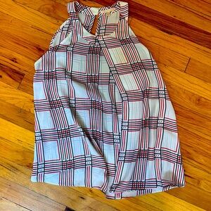 High neck, flowy, plaid, sleeveless blouse.